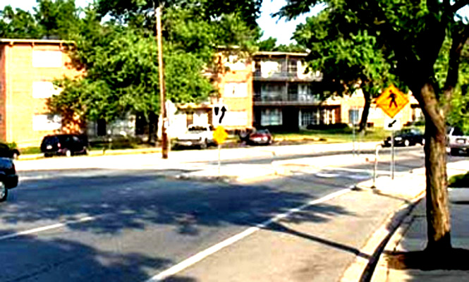 these 3 photos all show an intersection with a crosswalk from various angles.  The street is 5 lanes wide, including 2 parking lanes.  The crosswalk on one side of the street crosses 2 lanes (one of which is the parking lane), then passes through a refuge island that fills the middle lane, crosses one more lane and then passes through a bulbout (an extension of the sidewalk into the street) which blocks the parking lane